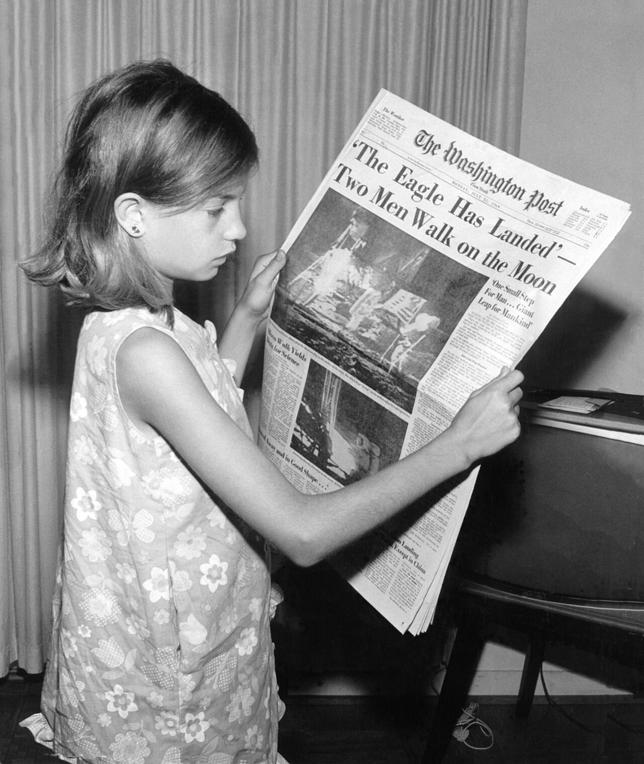 This is a picture of my mother holding The Washington Post newspaper on Monday, July 21, 1969 stating 'The Eagle Has Landed. Two Men Walk on the Moon'
