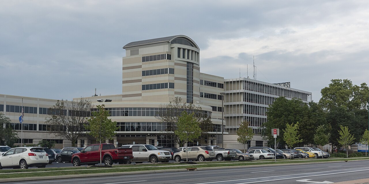 A southwest view of the front of Doctors Hospital, located on Broad Street (U.S. Route 40). A couple of license plates were slightly blurred to protec