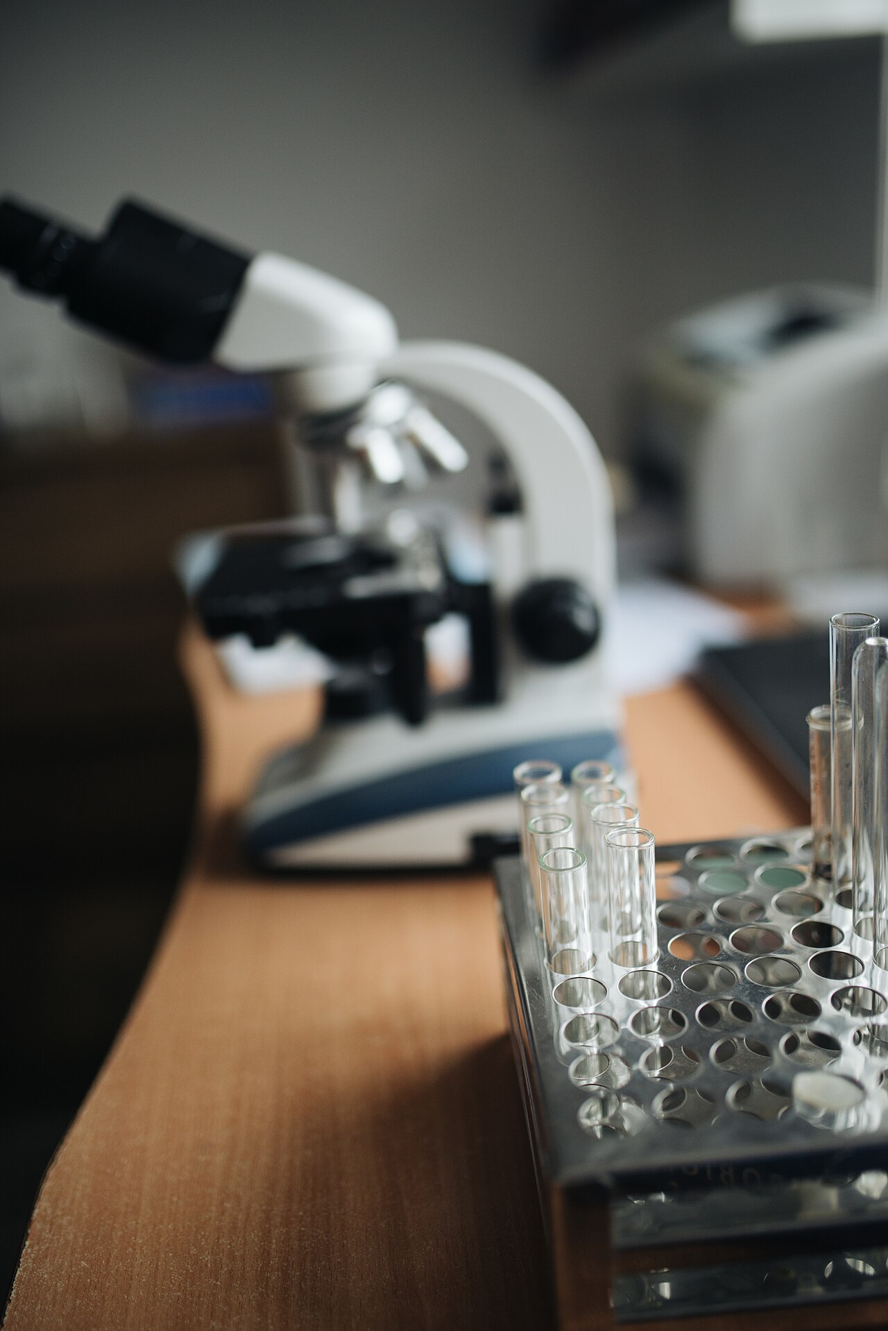 Close-up of the testing tubes with microscope in a blurry background